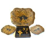 A Victorian black lacquered papier mache tray richly decorated with trailing gilt foliage