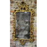 An 18th /19th century carved giltwood wall mirror with patinated plate,
