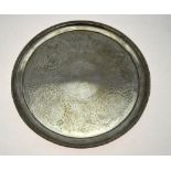 A Victorian circular silver salver with floral and foliate decoration, beaded rim and scroll feet,