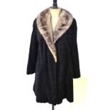 An astrakhan coat with deep grey mink collar with black satin lining,