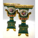 A pair of Continental porcelain vases, green ground decorated with raised gilding,