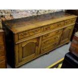 An 18th century oak low dresser, the three-plank top over three drawers,