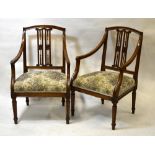 A pair of 19th century Italian provincial fruitwood open armchairs having pierced vertical spats