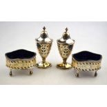 A pair of Adam-style pierced silver oval baluster pepperettes with engraved decoration,