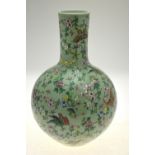 A Chinese Canton famille rose bottle vase, celadon ground decorated with butterflies,