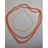 Two rows of coral beads, one graduated, one uniform to/w a row of small baroque natural pearls,