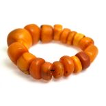 An amber bead bracelet, the seventeen plain beads of varying shape, size and colour, 57.