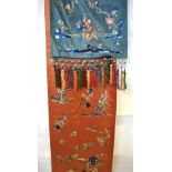 A Chinese blue silk panel depicting two exotic butterflies and floral sprays,