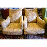 A pair of 19th century ear backed upholstered armchairs raised on short turned front legs and brass