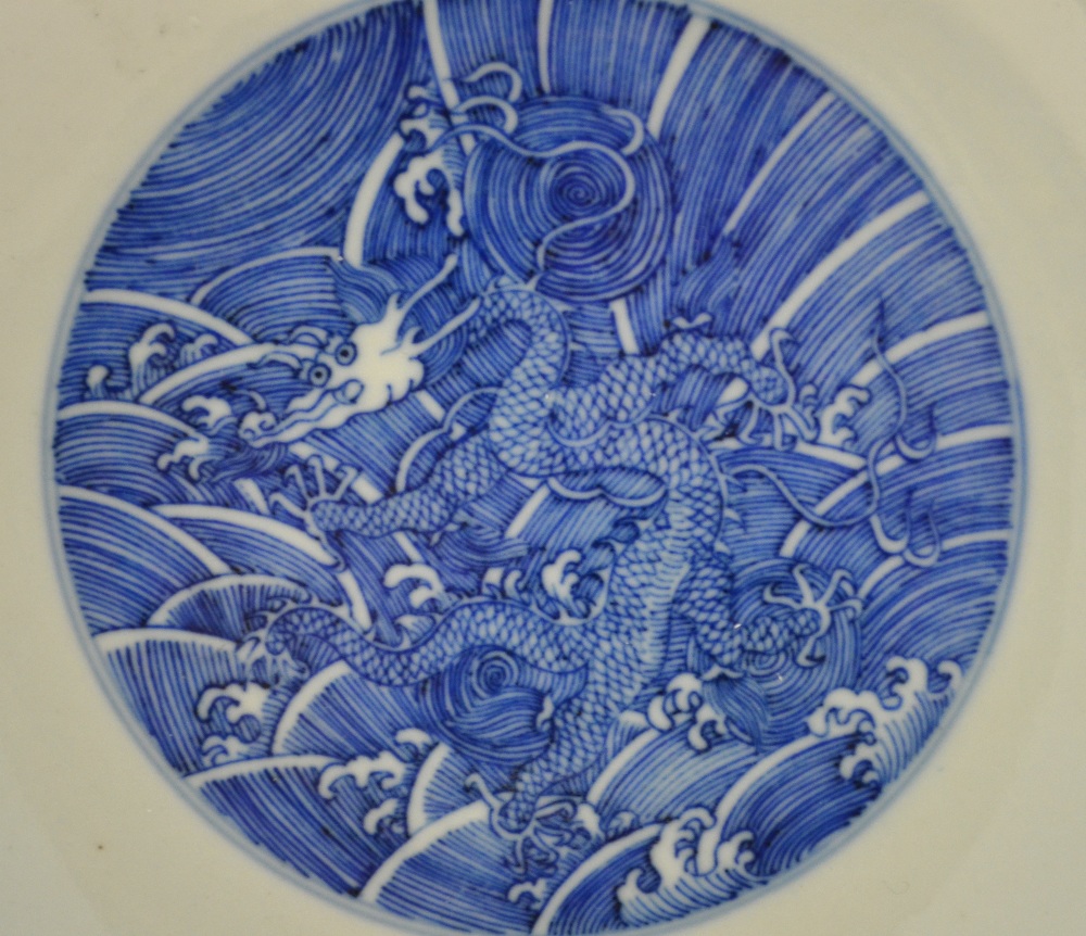 A Chinese blue and white saucer dish decorated to the centre with a dragon amongst waves, - Image 4 of 8