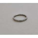 A full eternity ring set with eight cut diamonds, with engraved sides,