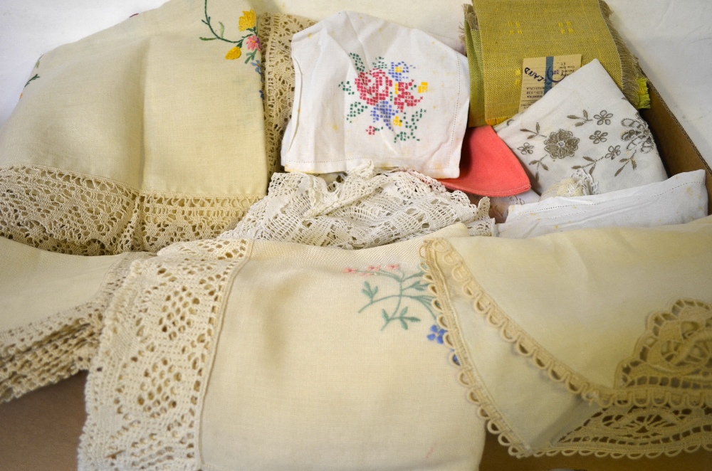 Three boxes of assorted table linen to include linen tablecloths with crocheted edges,