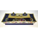 A 19th century French porcelain rectangular ink stand painted with floral cartouche on a blue