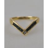 A yellow metal emerald and diamond-set wishbone style ring, collet set, stamped 14k, 3.