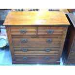 An Edwardian satin walnut chest of two short over three long graduated drawers raised on a plinth