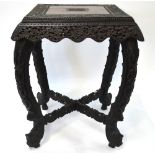 A 19th century profusely carved Anglo Indian Padouk wood centre table with pierced carved wavy