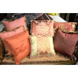 A collection of nine co-ordinating brocade and silk cushions in hues of vieux rose and cream,