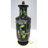 A famille noire rouleau vase decorated with figures in a narrative scene (possibly 'Outlaws of The