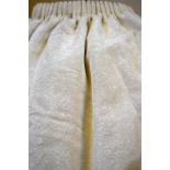 Two pairs of lined and inter-lined ivory grosgrain and embossed curtains,