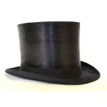 A vintage black silk top hat retailed by Wheeler & Comp'y, 14 to 17 Poultry, London EC, 55 cm circ.