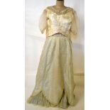 A Victorian pale eau de nil damascene brocade skirt with ivory silk floral sprays,