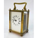 A lacquered brass carriage clock, the eight-day movement with white enamelled dial,