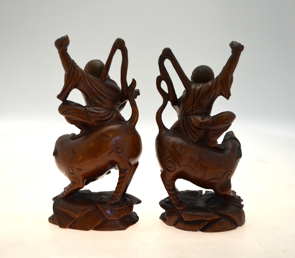 A pair of Chinese carved hardwood figures of ascetic Immortals riding a fabulous animal, 20 cm high, - Image 2 of 5