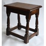 An antique oak joint stool, the single piece moulded edge top over baluster to block legs,