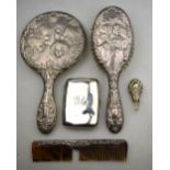 A cherub-embossed silver-backed hand-mirror with hairbrush and comb, Birmingham 1955,