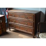 An 18th century oak continental commode, the plank top over three long drawers,