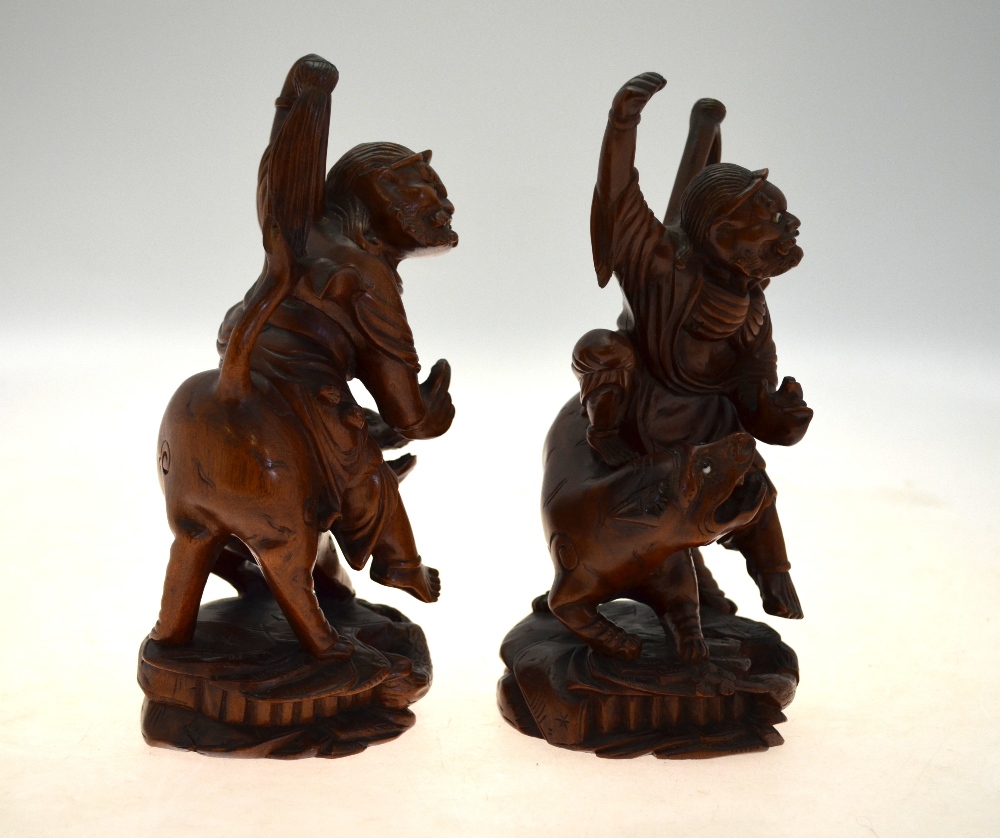 A pair of Chinese carved hardwood figures of ascetic Immortals riding a fabulous animal, 20 cm high, - Image 5 of 5