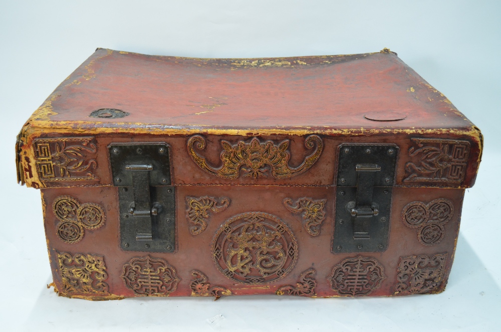 A Chinese red leather chest and cover of rectangular form,