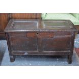 A small 17th century oak coffer, the two panel top over a conforming front and sides,