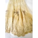 An early 1900s needle-run lace petticoat with applied ribbon detail, an embroidered lawn mob cap,