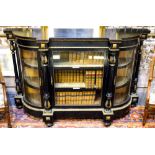 A Victorian ormolu mounted ebonised credenza having a glazed cabinet door flanked by full turned