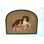 A 19th century padded wool, needlework and beadwork picture of a lap dog lying on a cushion,