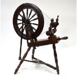 A 19th century chestnut and ash spinning wheel on turned supports Condition Report