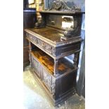 A late 19th century mirror backed carved oak buffet having two tiers over a pair of moulded