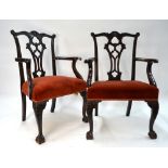 A pair of George III Chippendale style carved mahogany ear back armchairs with pierced shaped