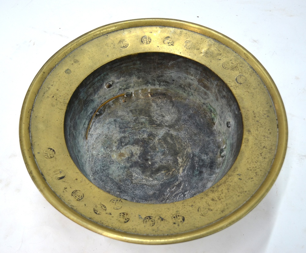 A brass or metal alloy tripod incense burner of circular form,