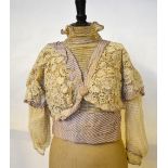 An Edwardian crocheted and net lace bodice trimmed with striped pale mauve/ivory silk,