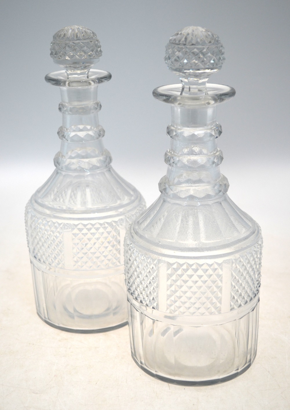 A pair of Georgian cut glass decanters;