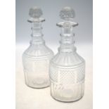 A pair of Georgian cut glass decanters;