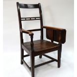 An 18th/19th century fruitwood and pine tavern open armchair,