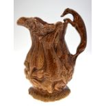 A 19th century brown glazed jug moulded with game - rabbits, ducks, fox, etc.