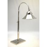 An electroplated Art Deco style desk lamp with flattened conical shade,