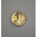 A pendant featuring Baden Powell and motto Justice and Empire