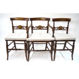 A set of eight Regency style brass inlaid walnut dining chairs with inlaid bar backs over shaped