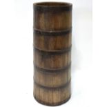 A 19th century coopered oak iron bound cylindrical tapering stick stand,