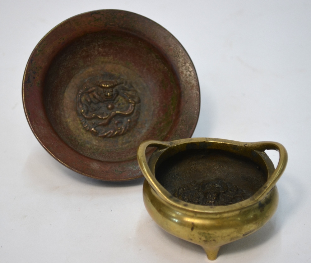 A small gilt metal tripod incense burner with two handles,